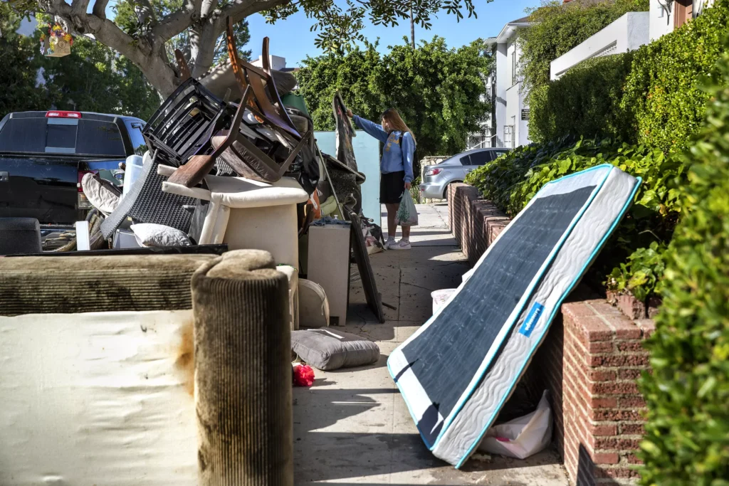 Residential Junk Pick Up- Old Furniture and Mattresses ready to haul away Pile of discarded furniture and mattresses on a residential sidewalk awaiting junk removal